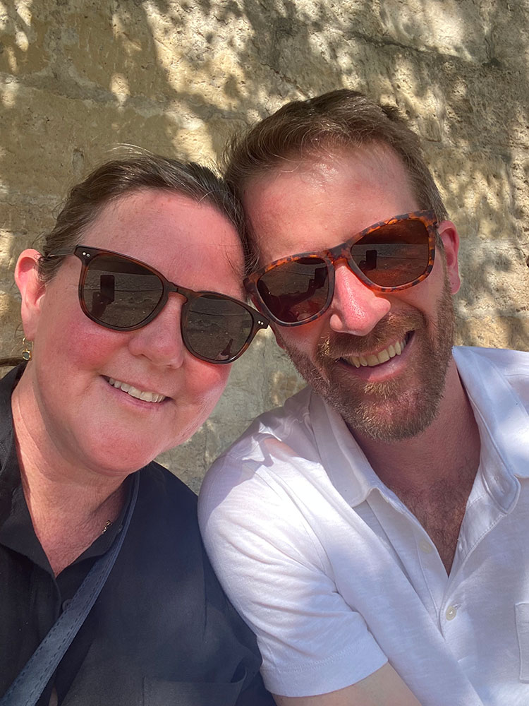 Seth Meyer and his wife wearing shades and smiling for picture.