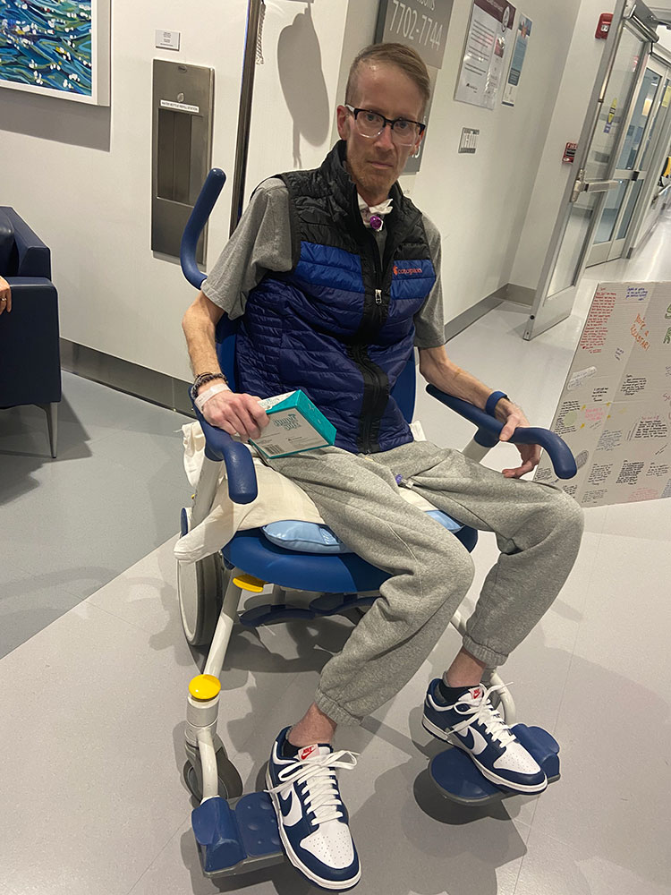 Seth Meyer sitting in a wheelchair in the hospital.