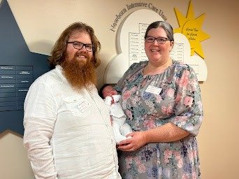 Kerrin Lucas, a Red Cross board member, with her newborn child and her partner.