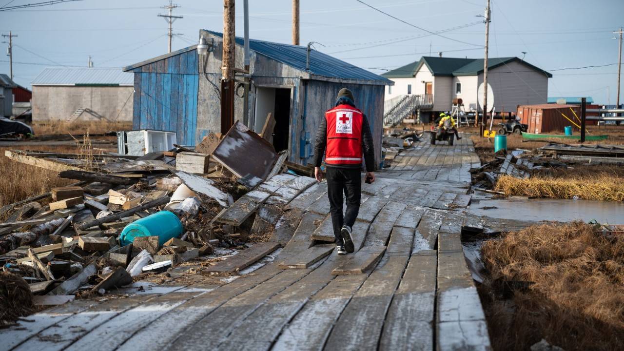 volunteers walking through damaged village