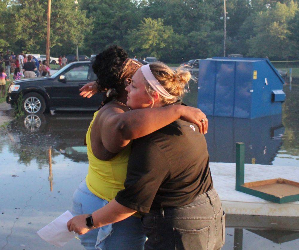 Ared cross volunteer hugging a client