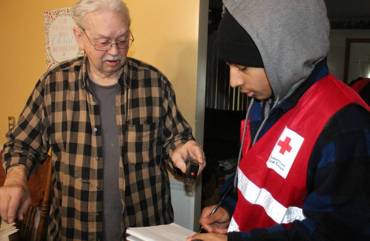 Red Cross volunteer shares fire safety information with a northern Ohio resident.