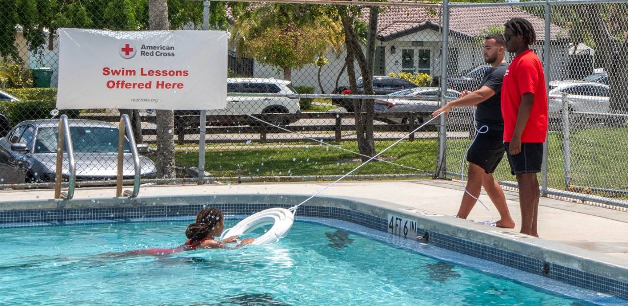 May 4, 2024.  Miami, Florida.This photograph illustrates a Water Safety Instructor® teaching swimming and water safety skills that are part of an American Red Cross Learn-to-Swim class delivered by a Red Cross training provider. Photo illustration by Jeanette Ortiz-Osorio/American Red CrossPlease note: these are staged photos and shouldn t be conveyed as a real event.