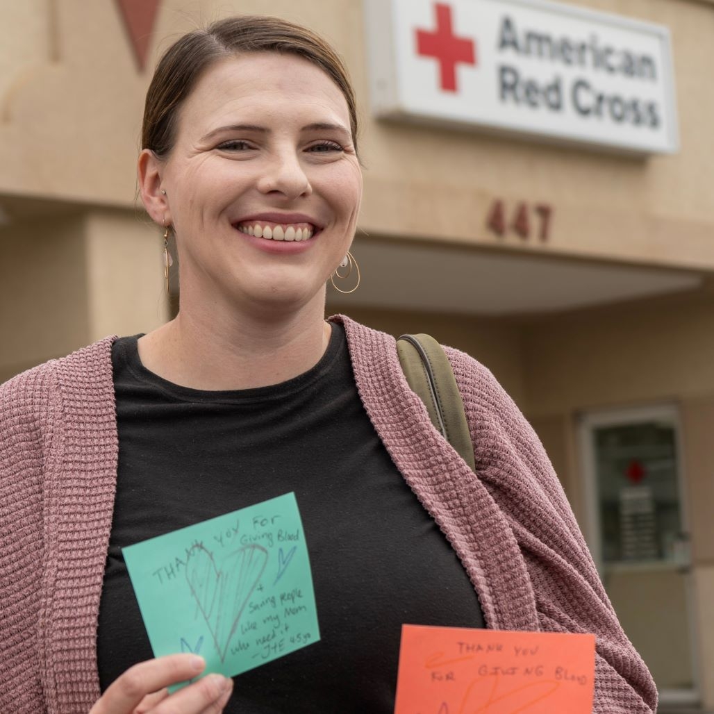 woman holding thank you cards