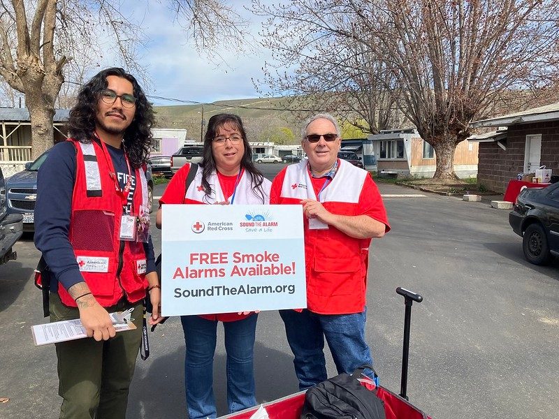 juan silva standing with other volunteers during sound the slarm event