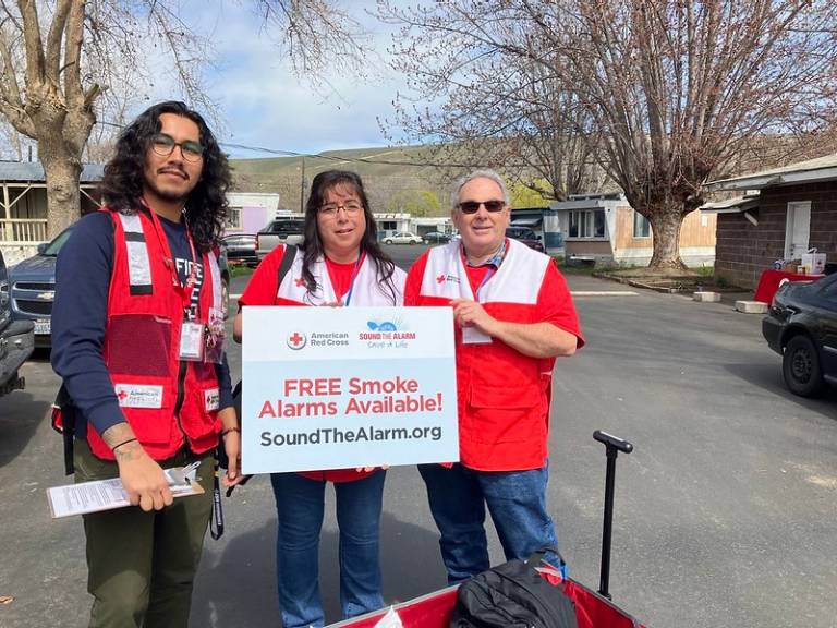 juan silva standing with other volunteers during sound the slarm event