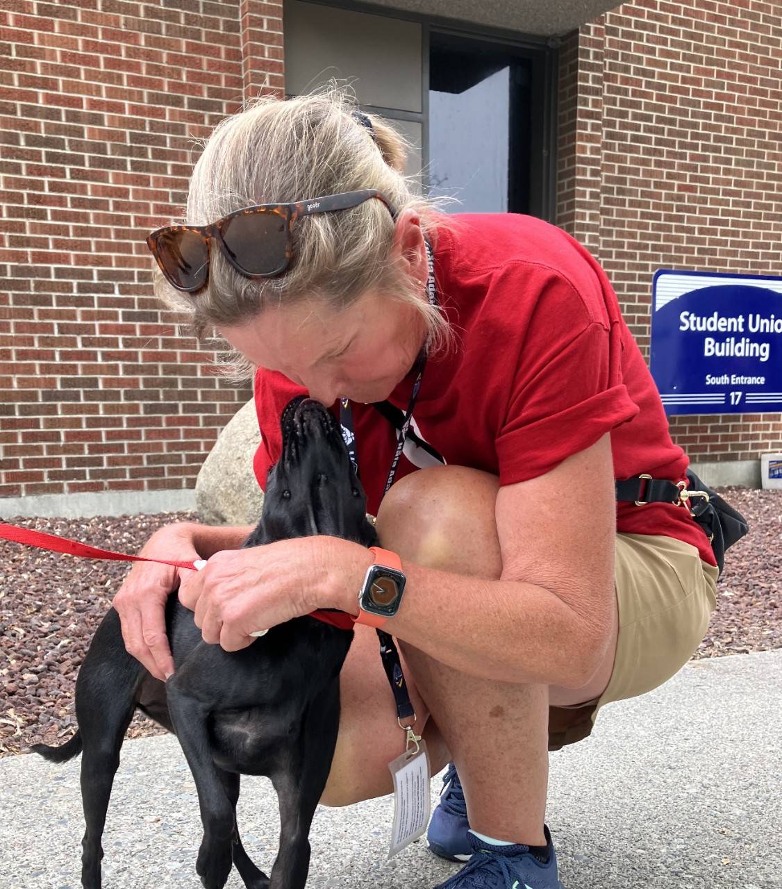 Paige McKee with a dog outside a building