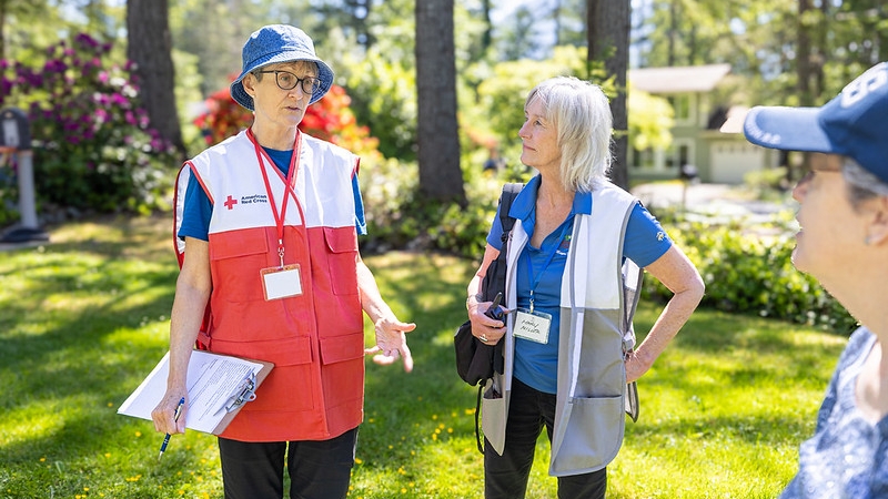 King County volunteer, Catherine Endicott and Mary Miller, Mayor of North Bend, Washington, share wildfire preparedness information with a resident.