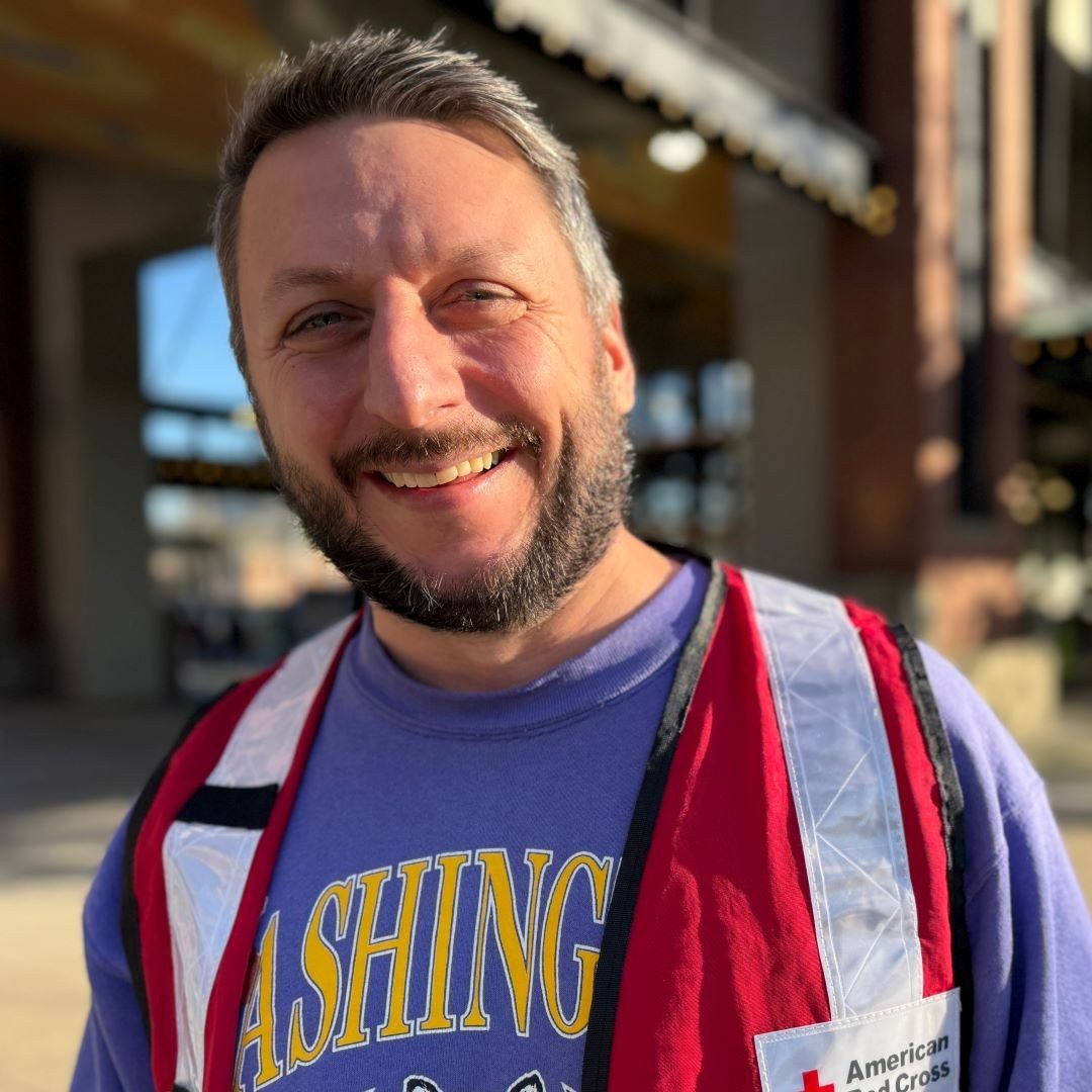 red cross volunteer smiling at camera