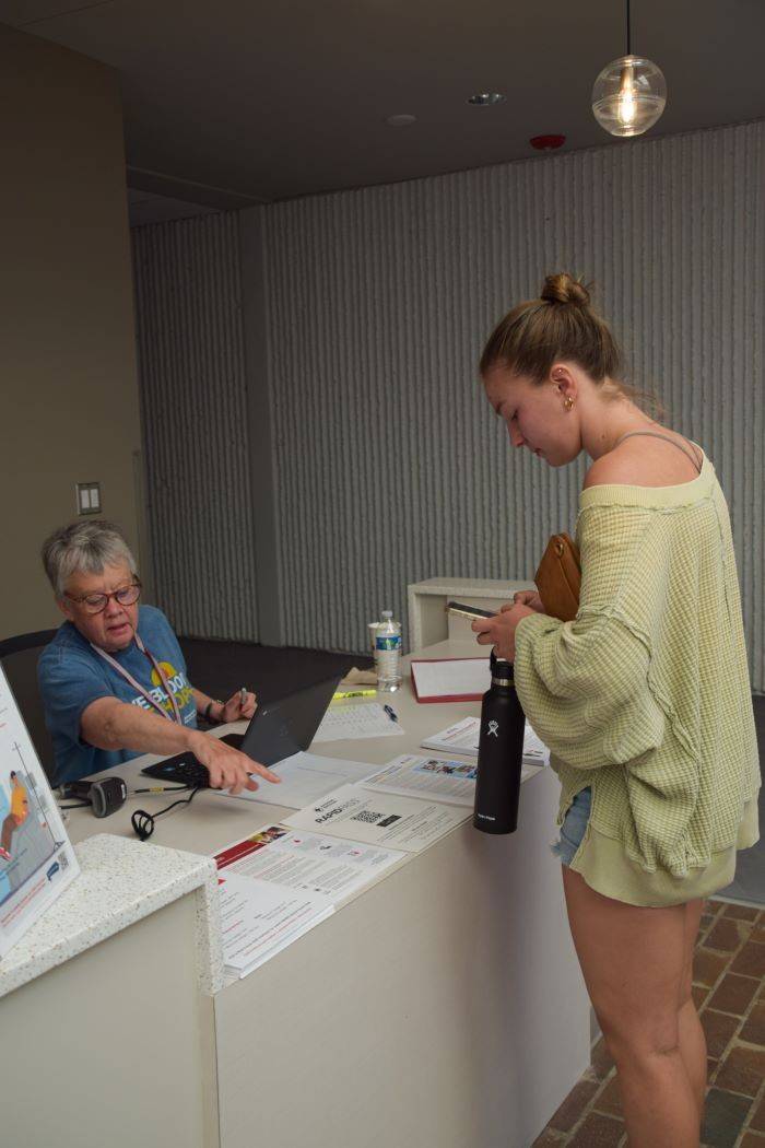 Carla Brenner checking in blood donor at table