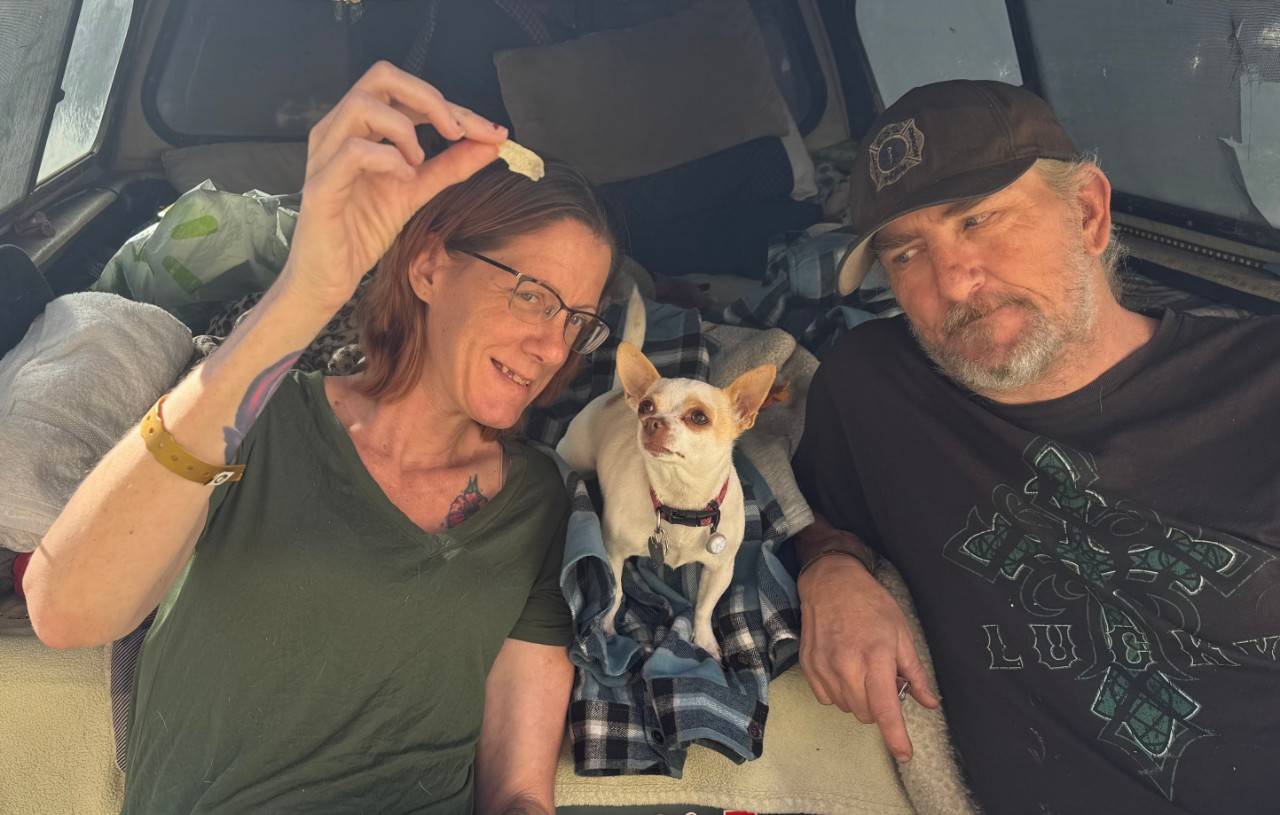 David Mequade and Jolene Bufford feed their chihuahua, Coco