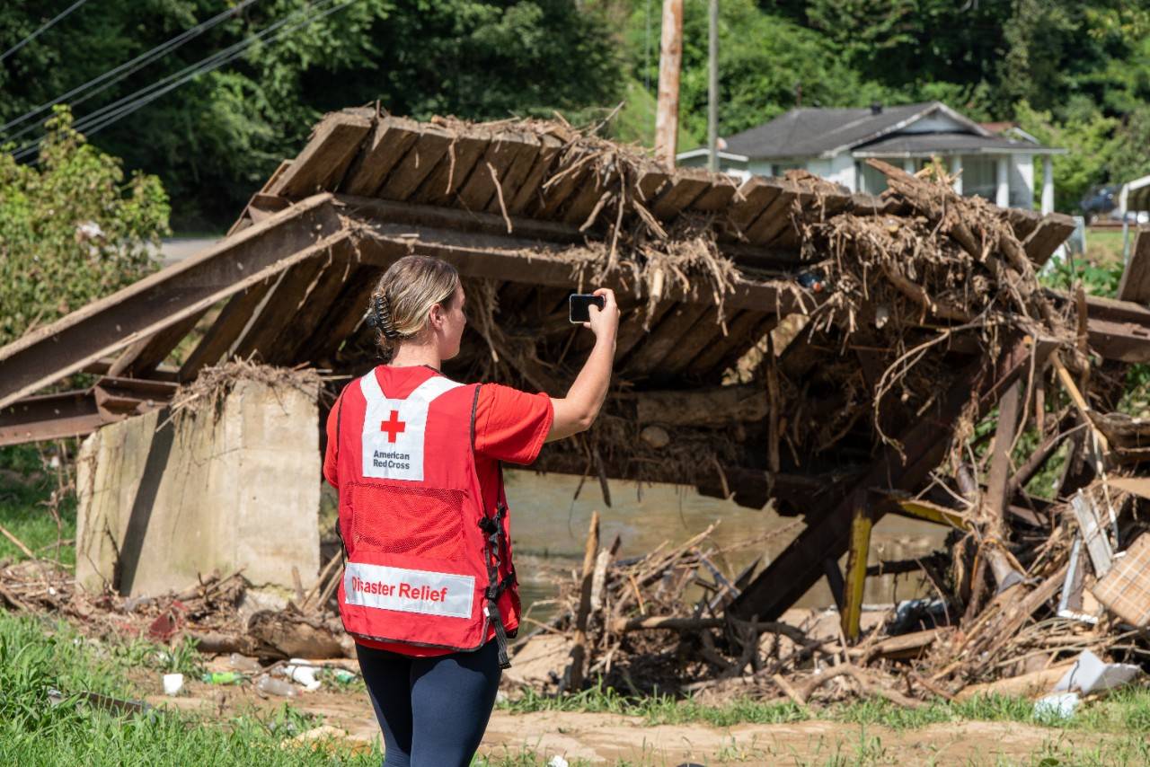 August 3, 2022. Virgie, Kentucky.
American Red Cross Damage Assessment Team member and Kentucky Region Disaster Program Manager, Madison Miller, uses the Red Cross Damage Assessment smartphone app to record home property damage suffered during the Kentucky flooding. The assessment app automatically records the location of the loss, stores photographs of the damage, and allows the Red Cross volunteer to categorize the extent of the loss so the Red Cross and partner organziations can plan recovery efforts and best respond to those affected.
Photo by Kevin Suttlehan/American Red Cross