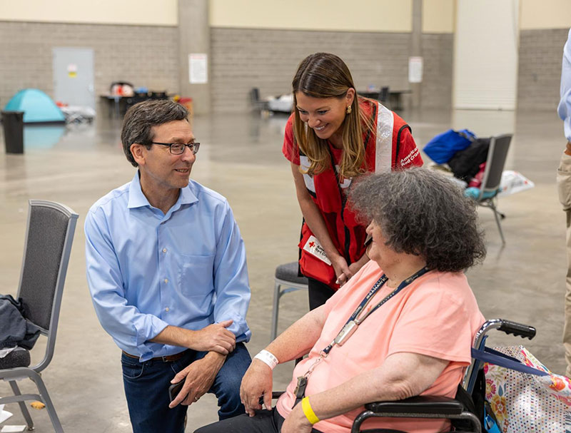 Governor Ferguson speaking with a person in a wheelchair.