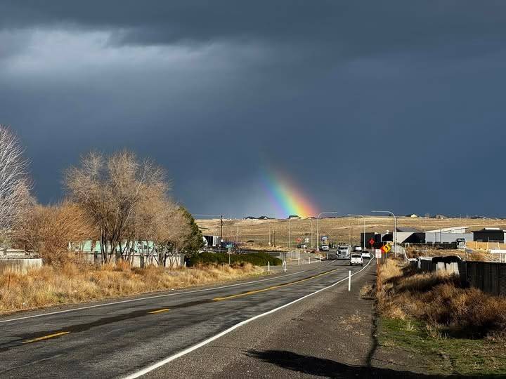 Photo of stormy sky with rainbow