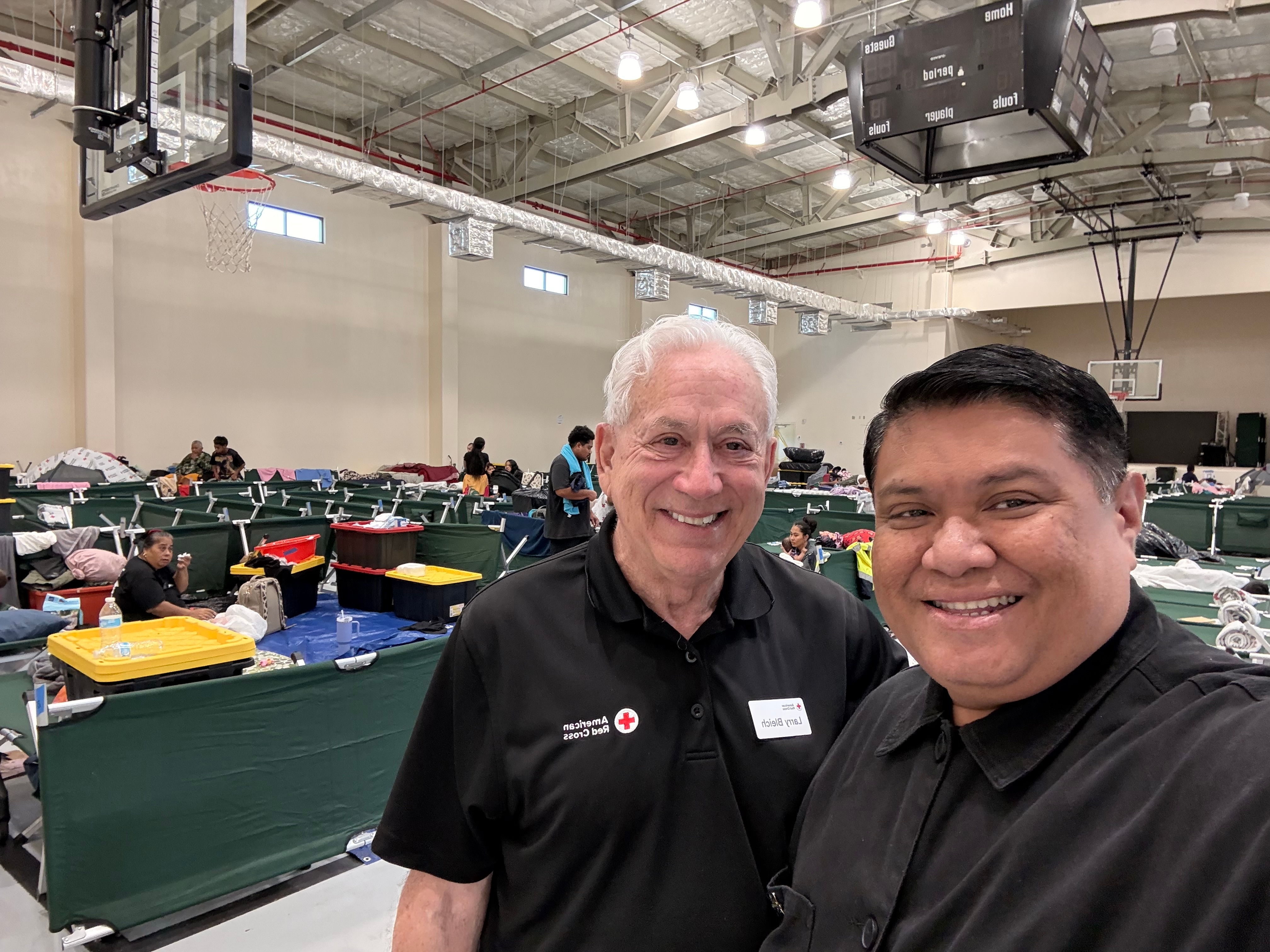 Two men stand inside Red Cross shelter