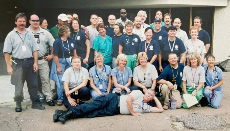 Matt stands within a group of volunteers at Hurricane Katrina.