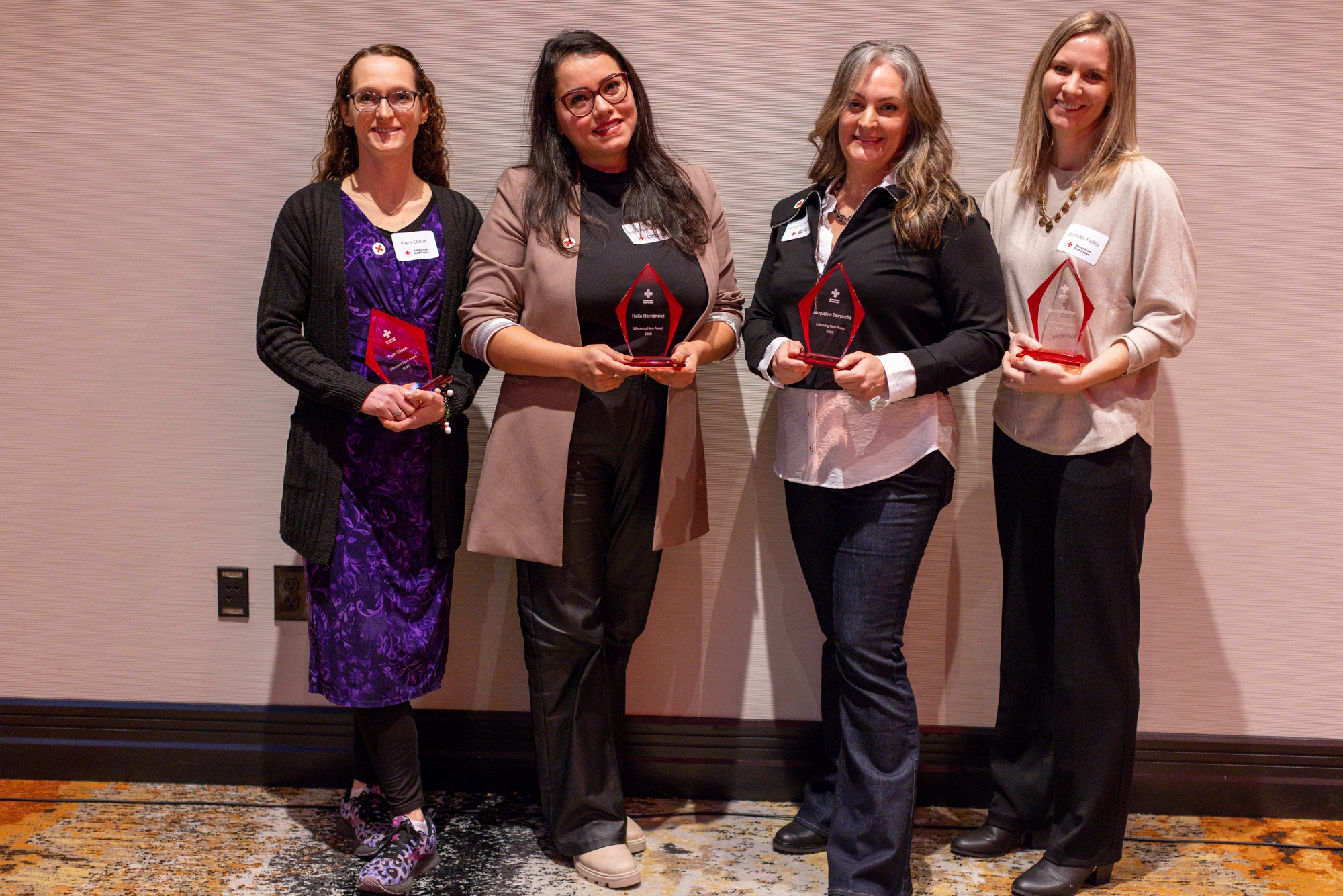 group of women holding lifesaving award trophies