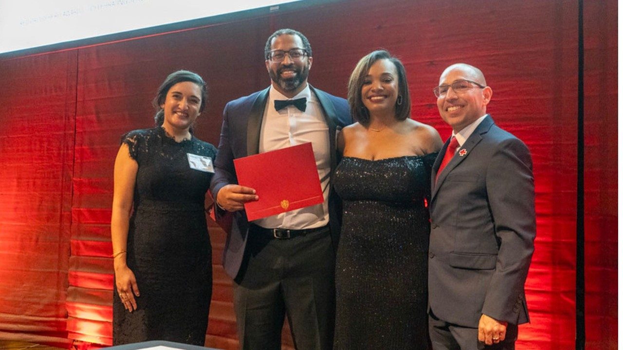 manny martinez with others holding award