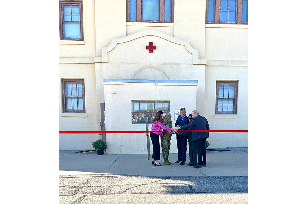 a ribbon cutting ceremony in front of a Red Cross building.