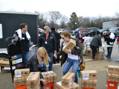 volunteers picking up boxes of smoke alarms