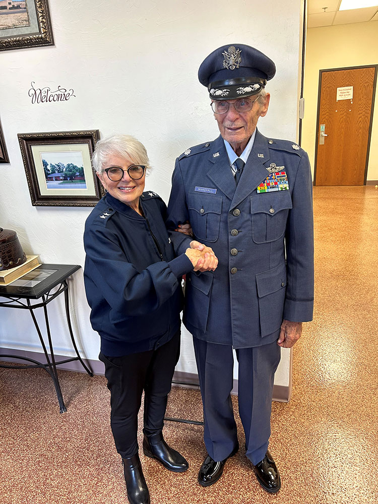 Lt. Col. Donald Marshall wearing full military uniform and shaking hands with Maj. Gen. LaRita Aragon.