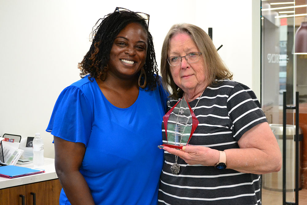 Central and Southwest Oklahoma Chapter volunteer Barbara Martin holding the Clara Barton Award for Meritorious Volunteer Leadership, stands next to Community Disaster Program Manager Kieulia Blackmon.