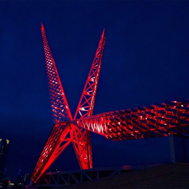 Skydance Bridge lit up red at night.