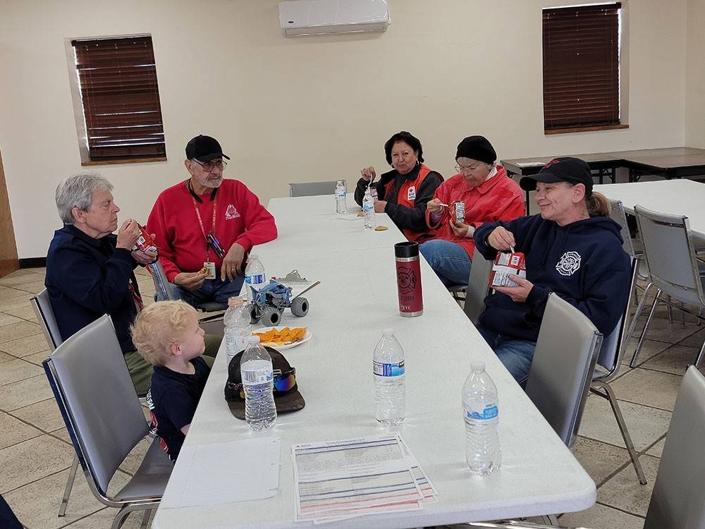 Red Cross volunteers eating at table