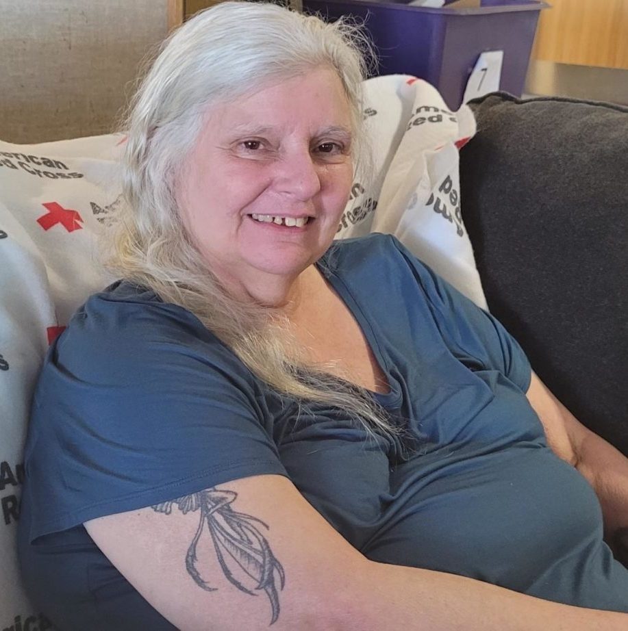 Barbett Grace, victim of a home fire, sitting in a chair