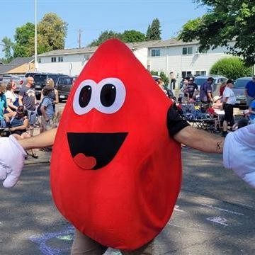Buddy the Blooddrop mascot in a parade
