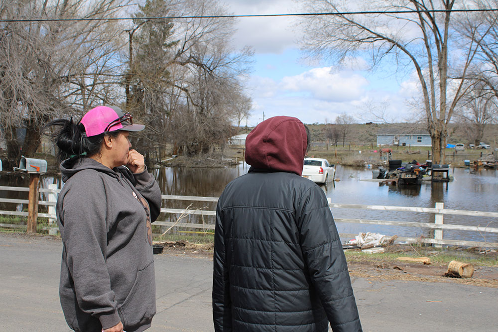 Burns Paiute Tribe members looking at flood damage to homes.