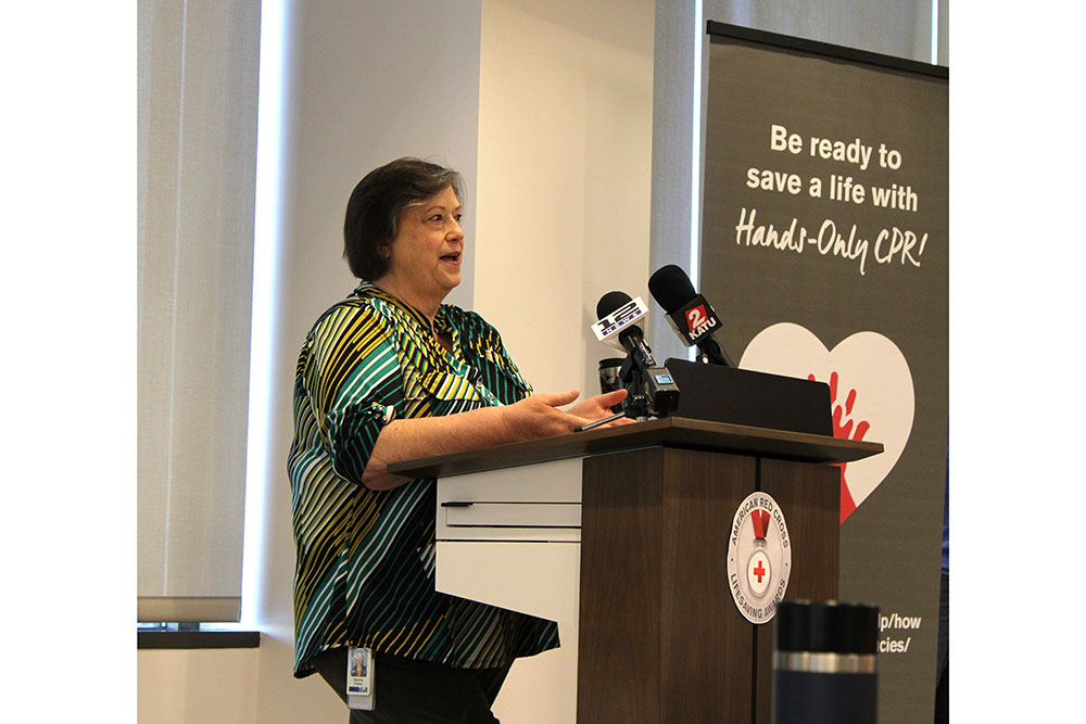 Deanna Premo speaking at podium at the Red Cross lifesaving awards ceremony.