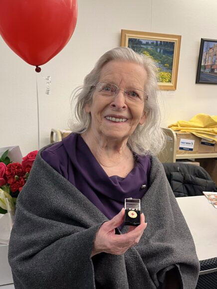 Elaine Yearsley proudly shows her 60 year pin.