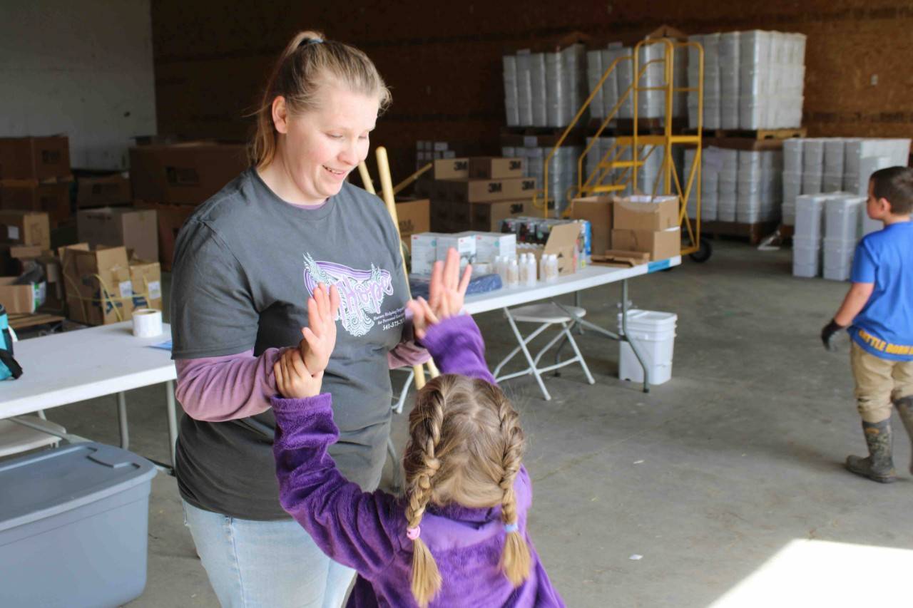 Erin Moss and a former preschool student who arrived to pick up supplies