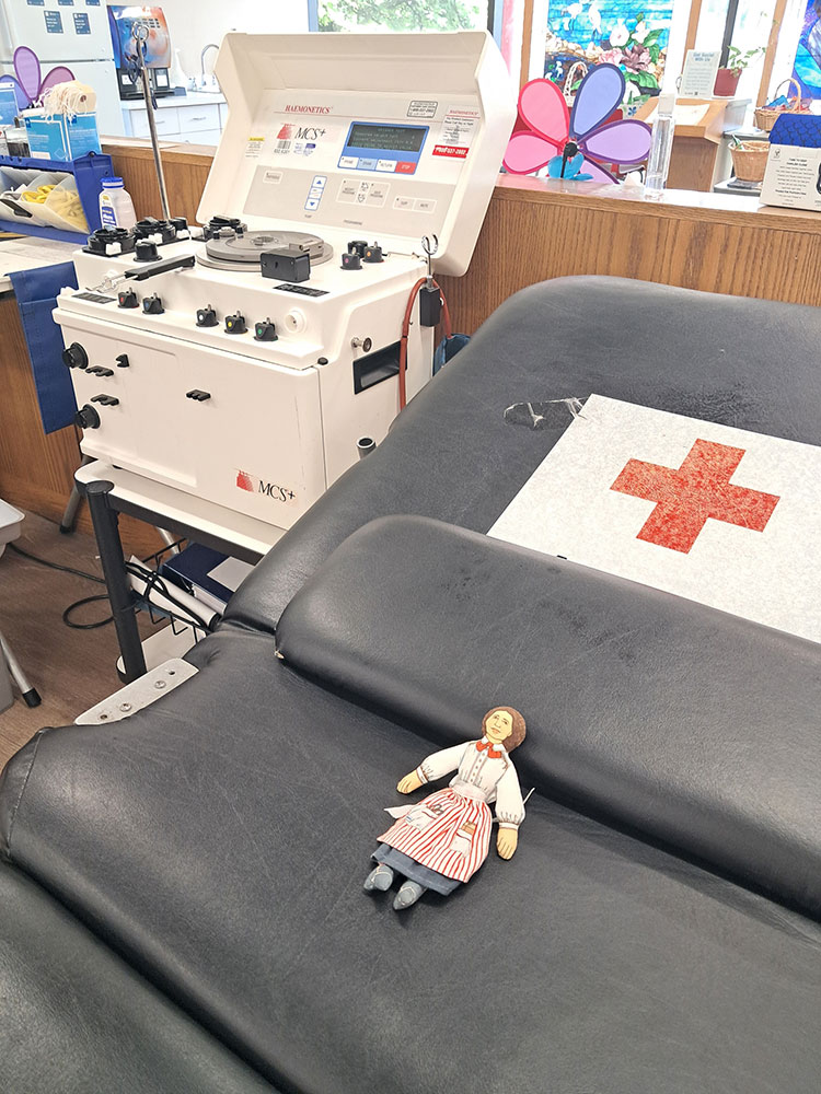 Flat Clara doll lying on a blood donation chair.