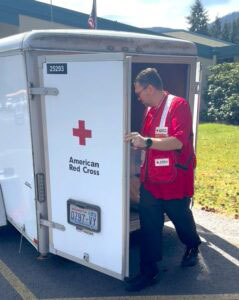 Red Cross volunteer John Himes checks inside of a Red Cross trailer.