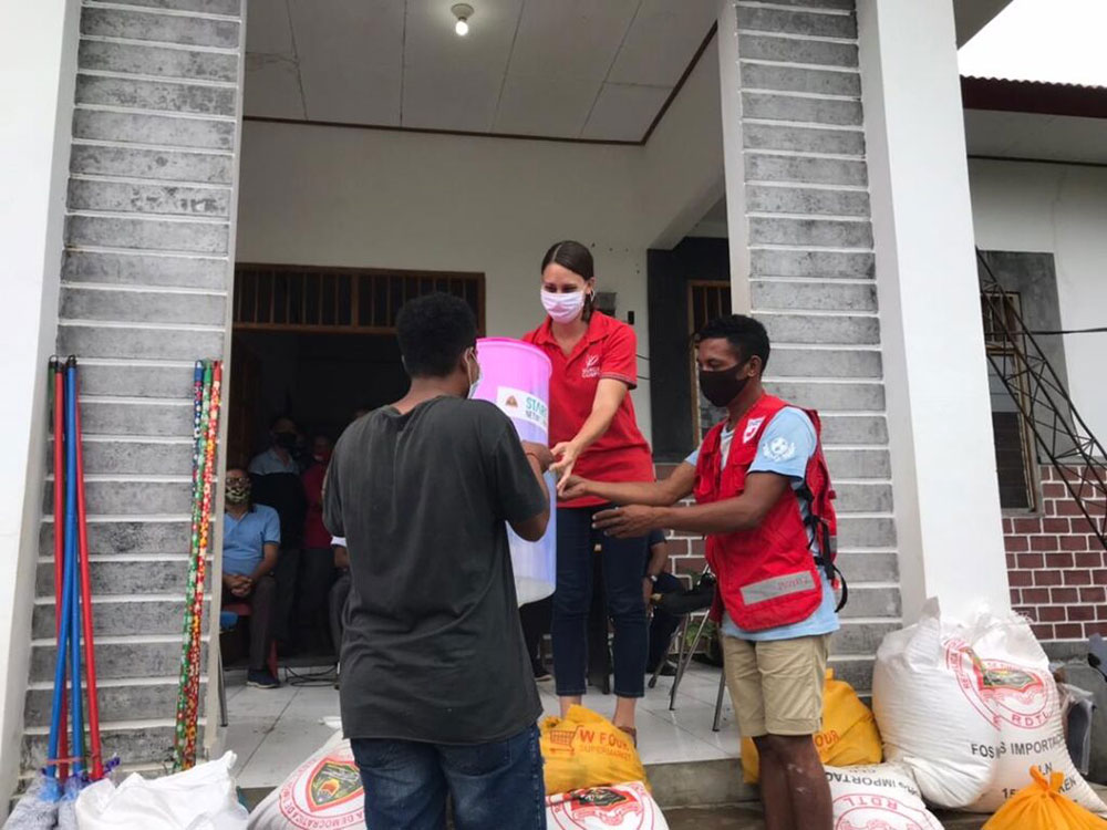 Kirsten Mandala and a Red Cross volunteer helping a local at a shelter.
