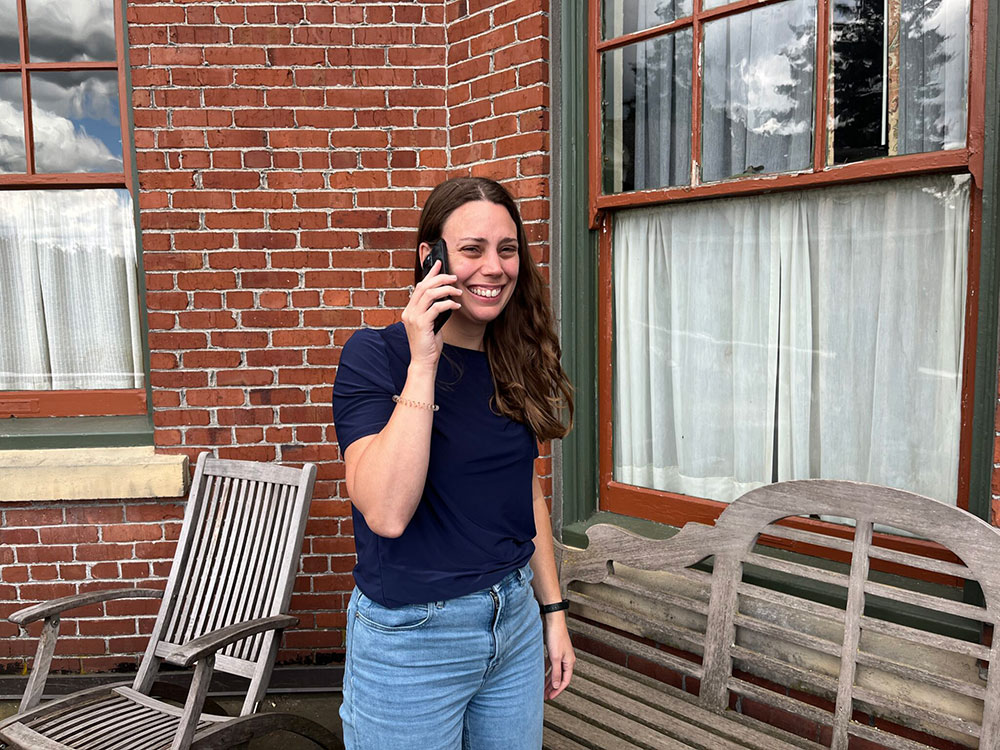 Kirsten Mandala outside and speaking on a smartphone.