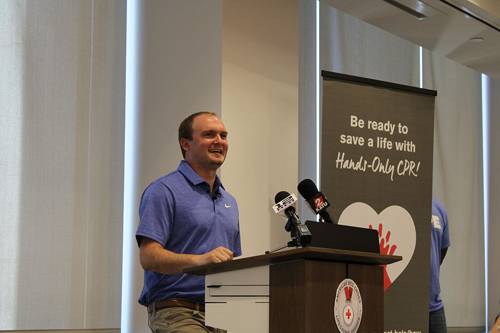 Ryan Hover speaking at podium at the Red Cross lifesaving awards ceremony.