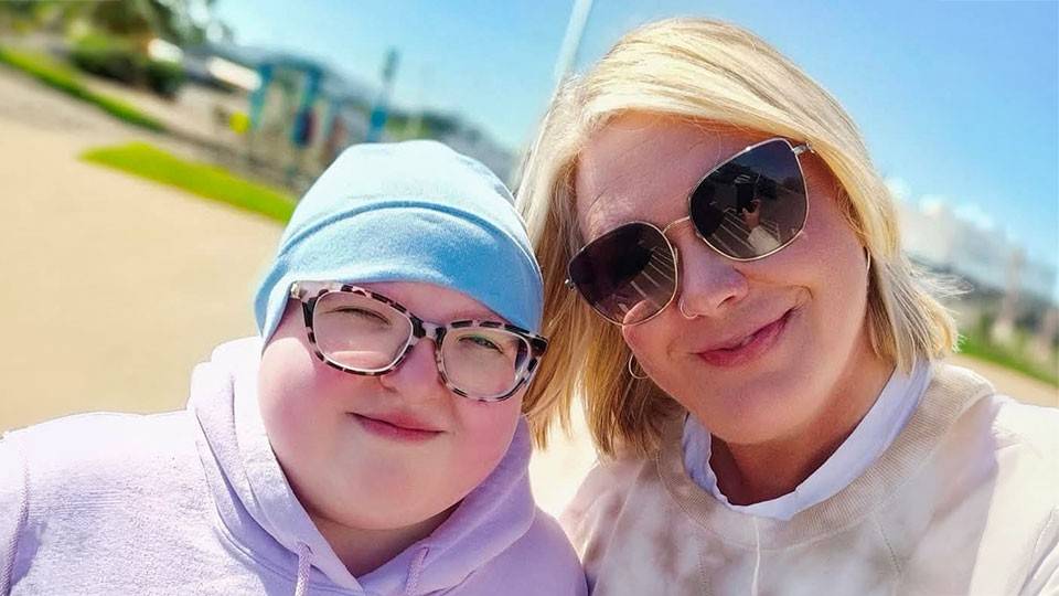 Nicole Ek, wearing sunglasses, and daughter Emmie, wearing beanie and glasses.