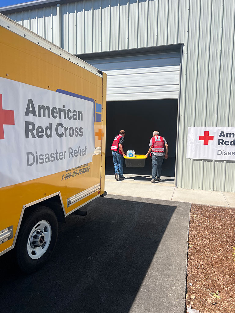 American Red Cross Disaster Relief moving truck being unloaded by volunteers.