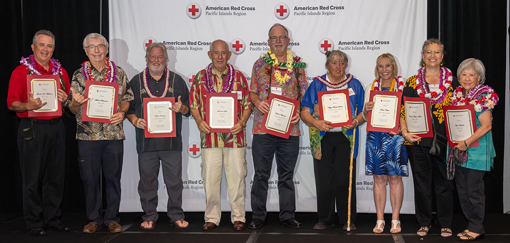 group photo of the 2026 Volunteer Hero awardees at a red cross event holding their awards.