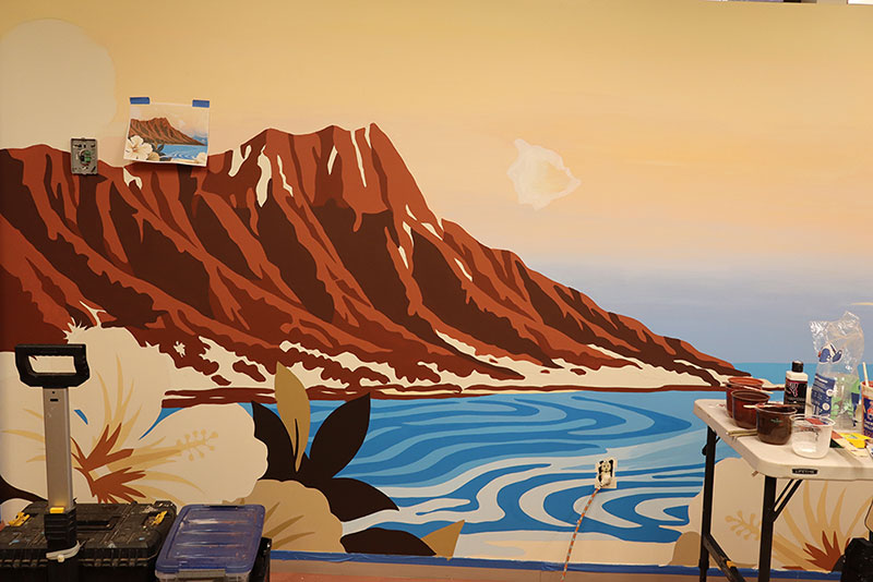 Mural painting on the inside wall of a Red Cross building of a flower, lake and mountain.