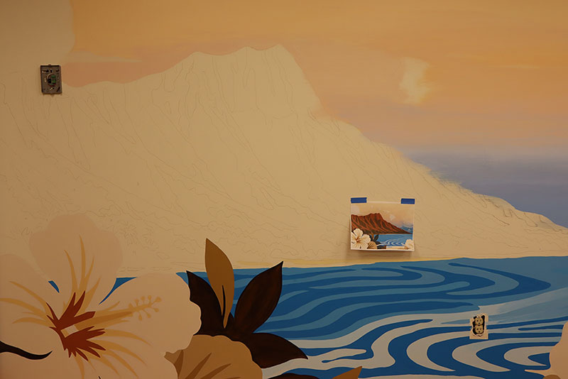 Mural painting on the inside wall of a Red Cross building of a flower, lake and mountain.