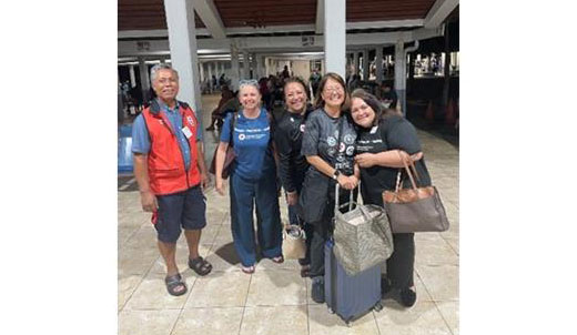 Red Cross staff members and American Samoa Board members group pic in an airport.