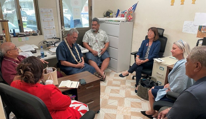 Red Cross staff members and American Samoa Board members meeting in an office.