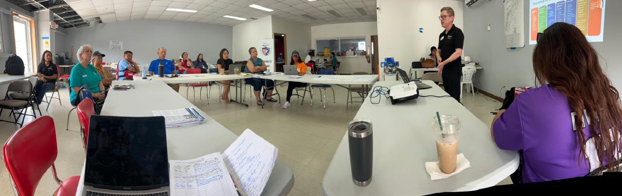red crosser speaking to small group