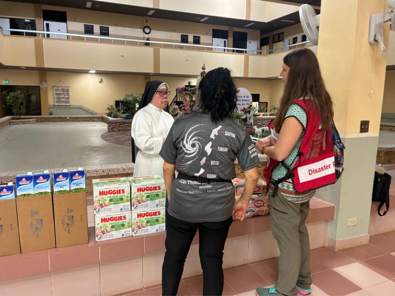 red crossers speaking with church members