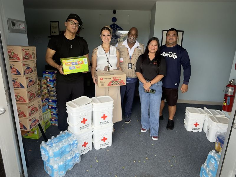 group of people holding supplies