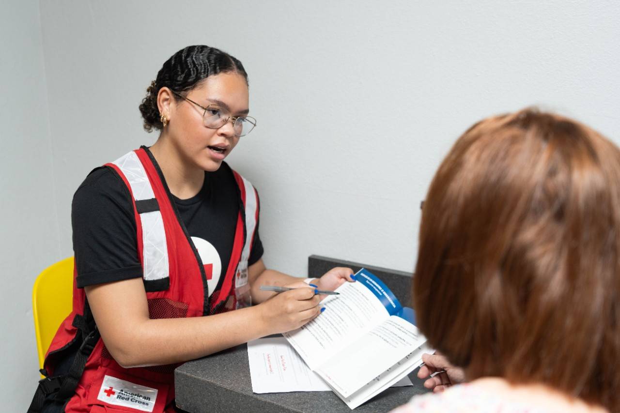 February 17, 2024. San Juan, Puerto Rico.
Volunteer Alanis Mercado goes through the preparedness brochure for senior adults.
Photo illustration by Juan Carlos Molina Padilla/American Red Cross

Please note: this is a staged photo and shouldn't be conveyed as a real event.